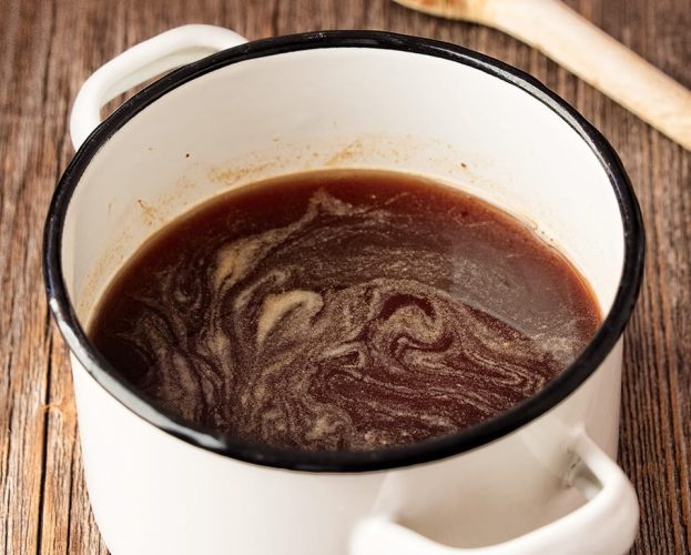 lamb gravy in a white pan
