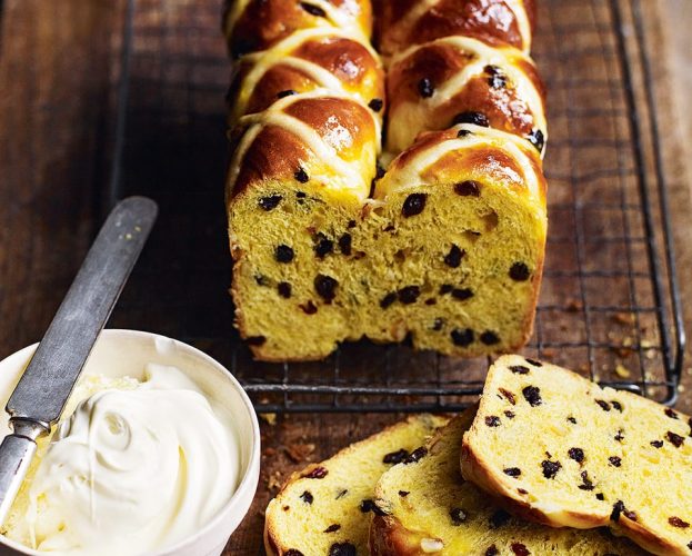 Hot cross bun loaf, shown sliced on a wooden board