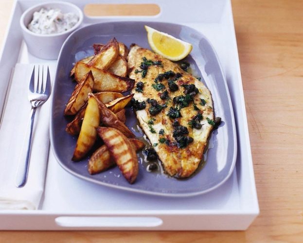 Pan-fried plaice with potato wedges, on a plate