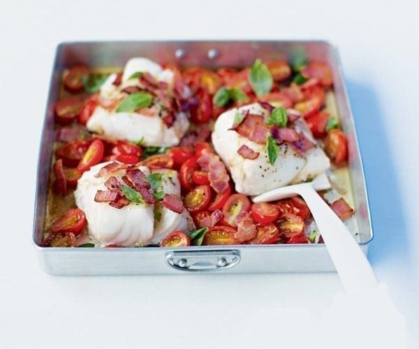 Roast cod with tomatoes in a baking tray