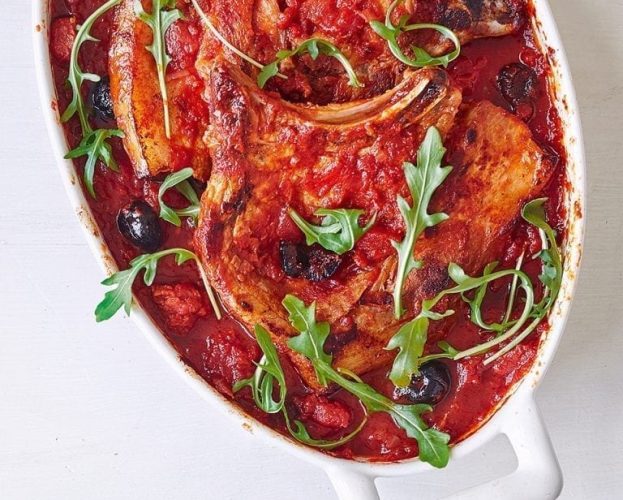 Pork chops with chorizo in a white serving bowl