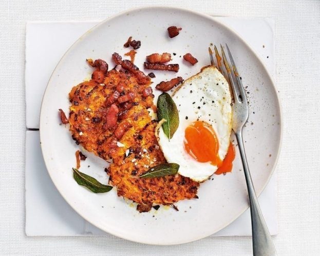 Butternut fritters shown on a plate, with a fried egg and fork