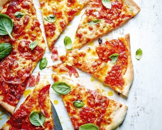 Sloppy Joe pizza shown cut into slices
