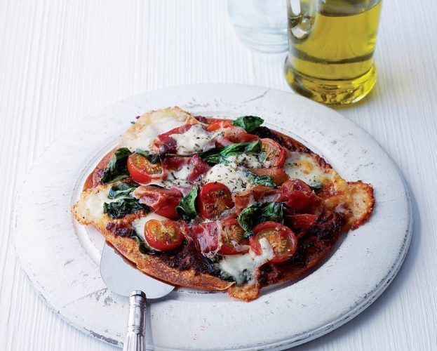 A loaded up pizza 'wrap' on a plate