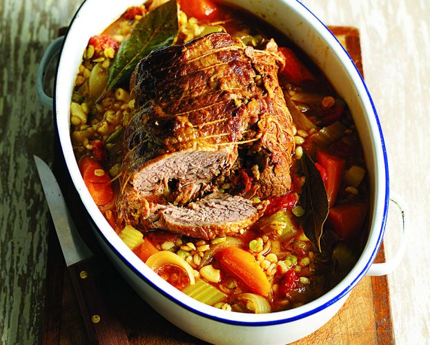 Beef stew made with brisket, shown in a white casserole dish