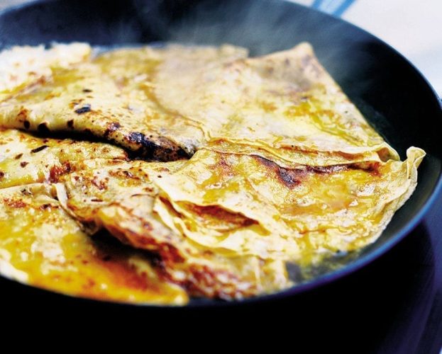 Crepe suzette in a black frying pan