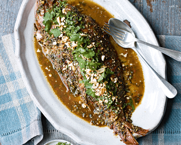 Whole baked snapper shown on a white plate