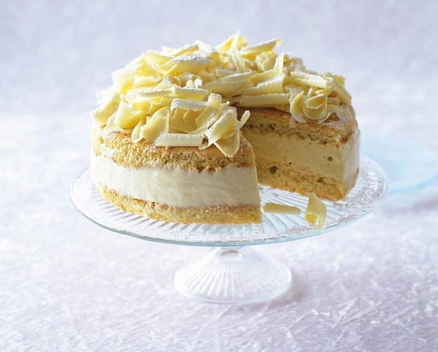 White chocolate torte celebration cake on a glass stand