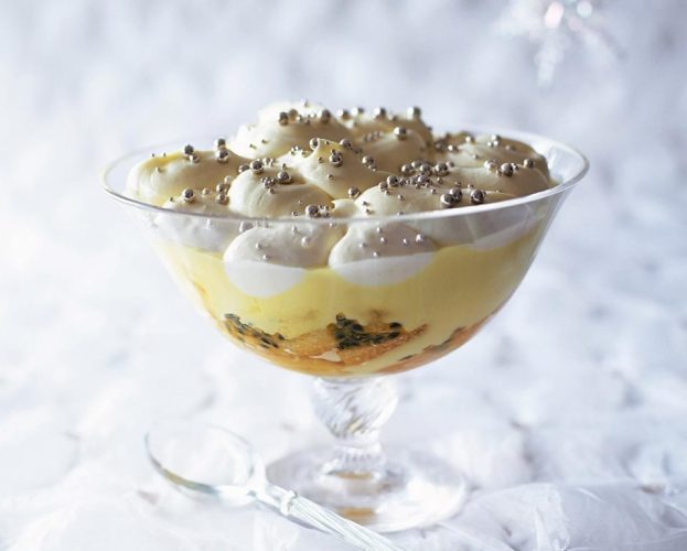 A trifle shown in a stemmed glass bowl.