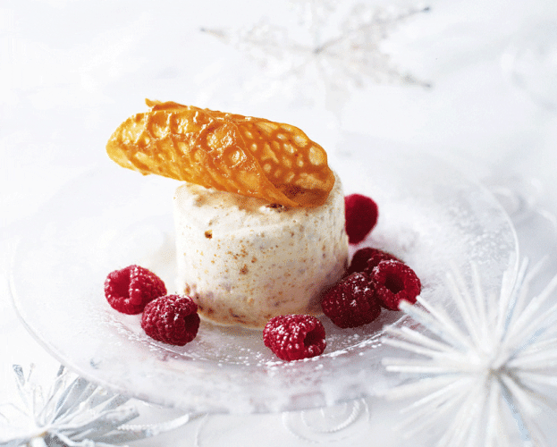 brandy snap shown on top of a white round amaretti tortoni