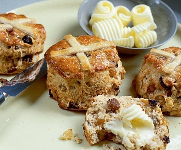Hot cross scones shown on a plate, with butter curls