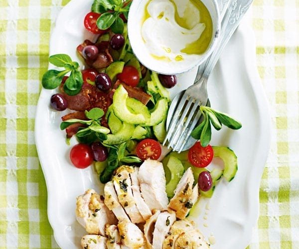 Greek chicken salad with oregano, olives and tomato