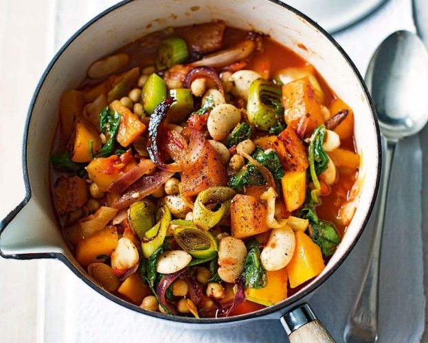 Colourful butterbean stew shown in a white pan