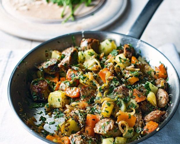 Sausage and potato hash shown in a frying pan