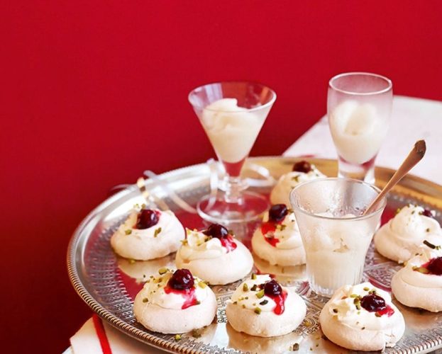 Mini decorated meringues shown on a silver tray