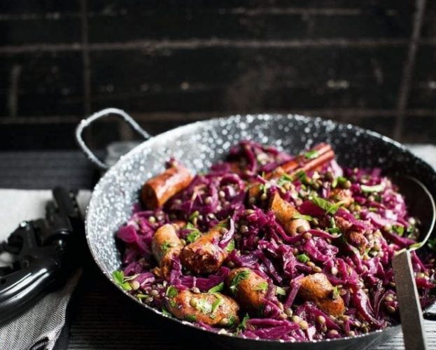 Braised red cabbage with merguez sausage and lentils, shown in a metal pan