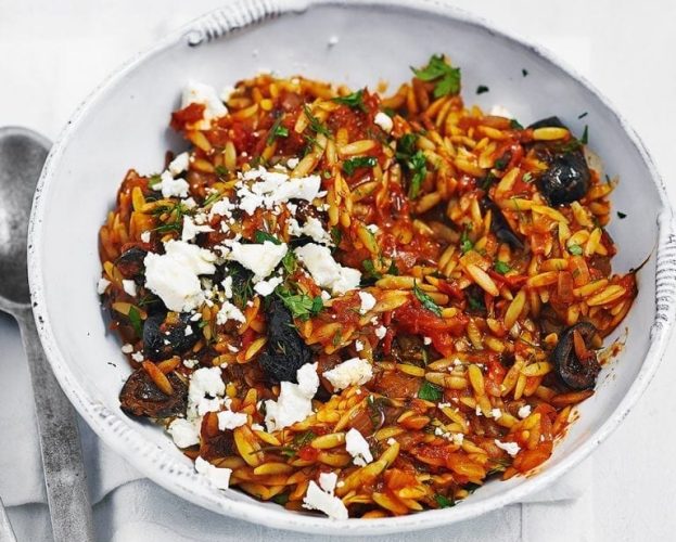 Orzo pasta with tomato sauce in a white bowl