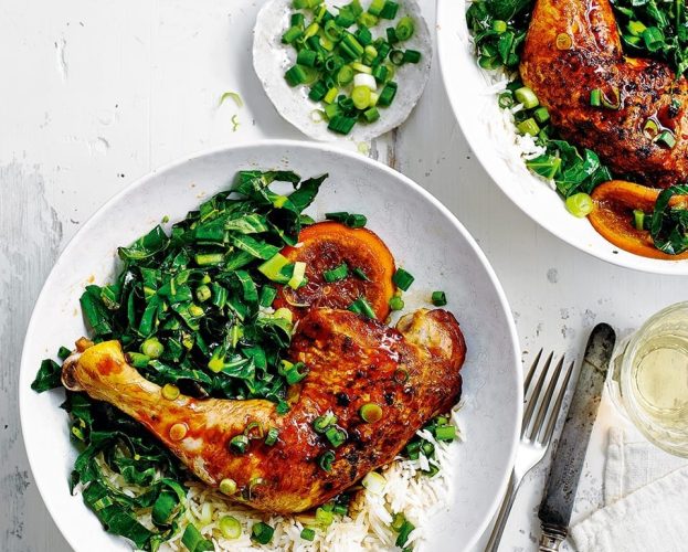 Sticky chicken tray bake shown on a white plate