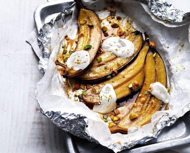 Maple and rum baked bananas with toasted hazelnuts and pistachios
