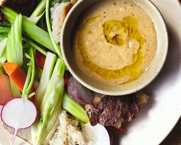 A bowl of bagna cauda tip with crudités