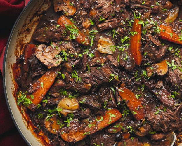 An overhead view of a casserole dish containing beef bourguignon