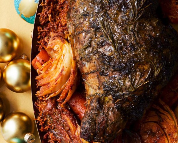 Tamarind and herb-stuffed lamb leg on a bed of jollof rice