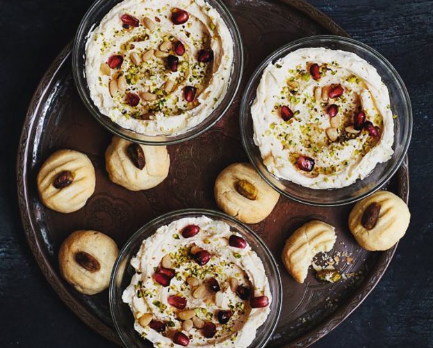 Three individual dishes of syllabub served with pistachio biscuits
