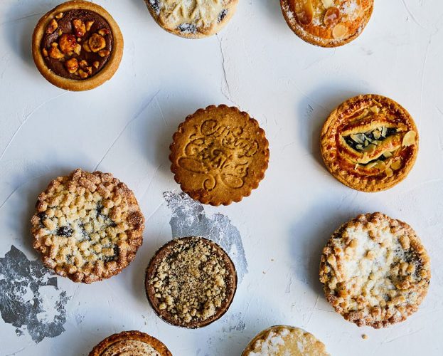 An assortment of mince pies of a white and silver background