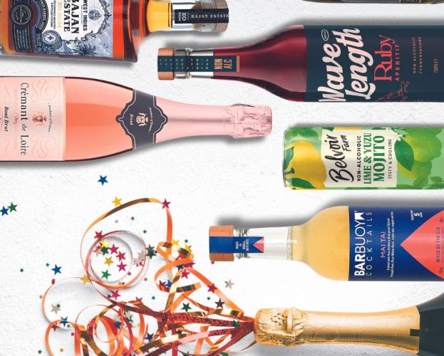 Bottles lying on their sides. One has a festive ribbon decoration popping out
