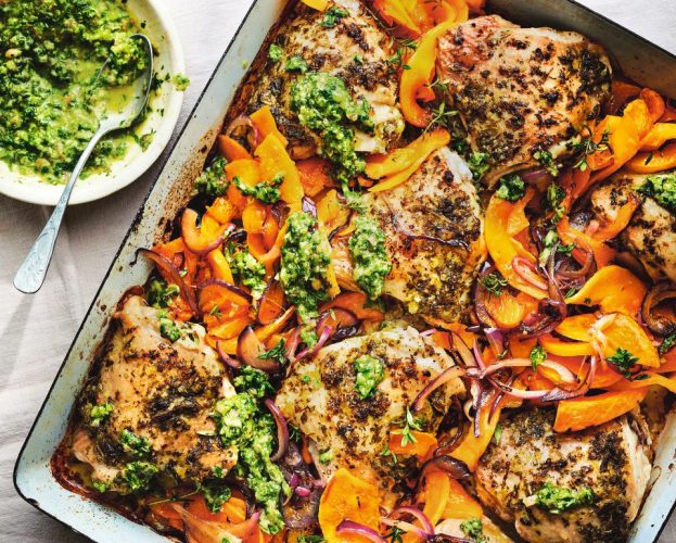 A chicken traybake with squash and bright green chimichurri sauce