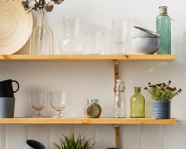 An Instagrammable kitchen design featuring wooden shelves with crockery and glassware