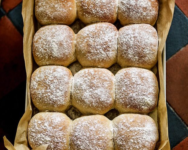 A tray of 12 blaas (square Irish bread rolls, dusted with flour)