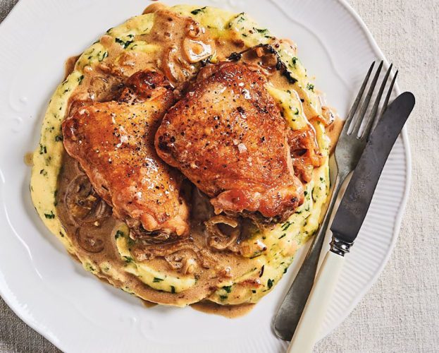 Vinegar chicken shown cooked on a polenta