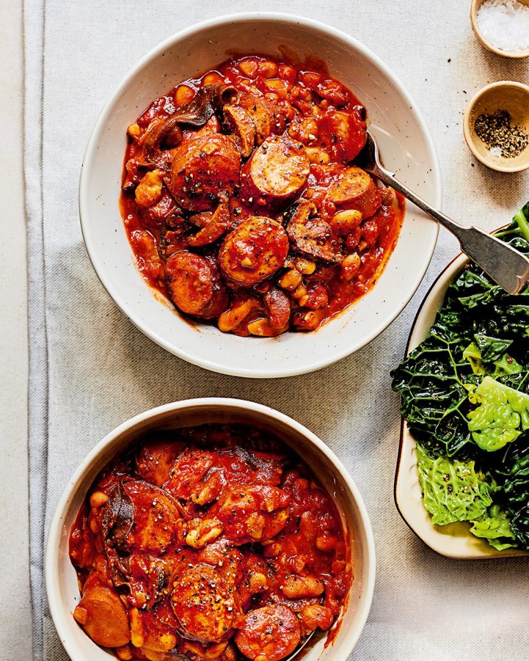 Smoked sausage, mushroom and bean stew in two white bowls