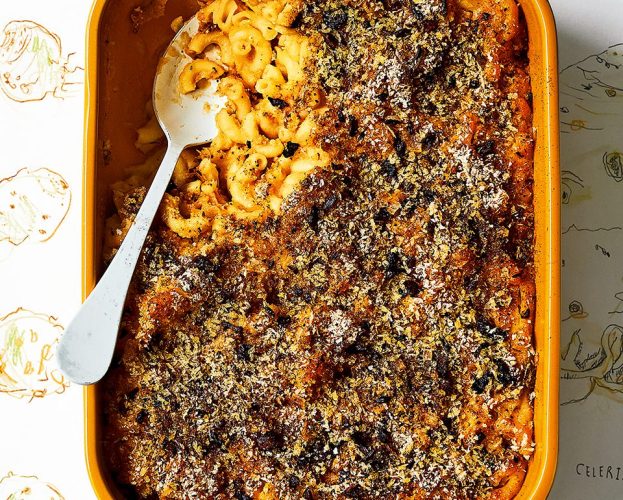 Vegan celeriac mac and cheese in an oven dish with a spoonful removed
