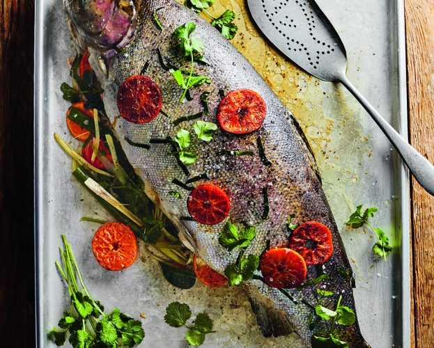 Roast trout with clementine, ginger, spring onion and herbs