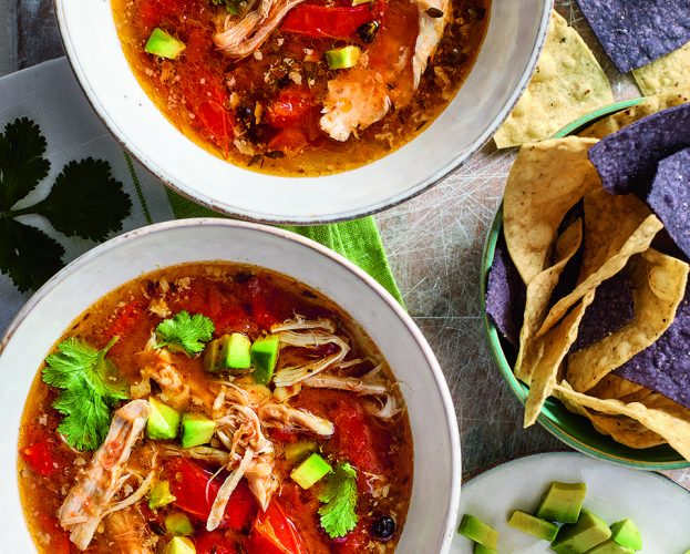 Slow cooker citrus chicken broth with tortillas and avocado