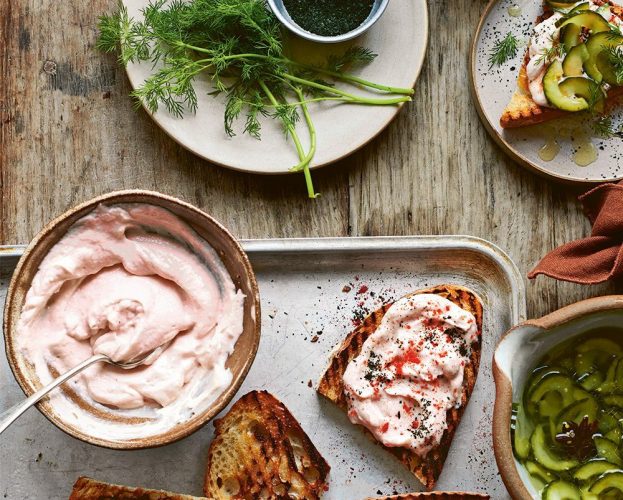 A bowl of taramasalata, next to taramasalata spread on toast
