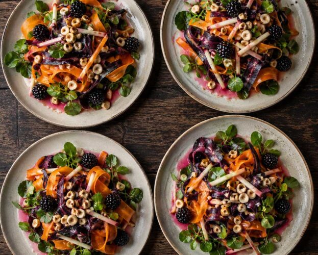 Carrot and cobnut salad with apple matchsticks, watercress and whole blackberries in a pink blackberry dressing