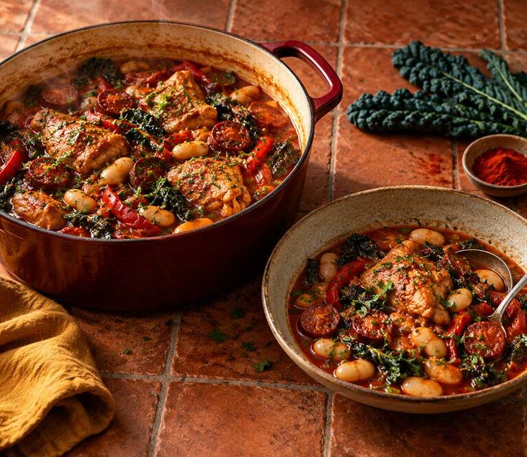 Bowl and casserole of pheasant stew with chorizo, butter beans, cavolo nero and parsley